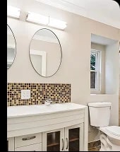 West Springfield bathroom after renovation, with a tile backsplash and bright paint